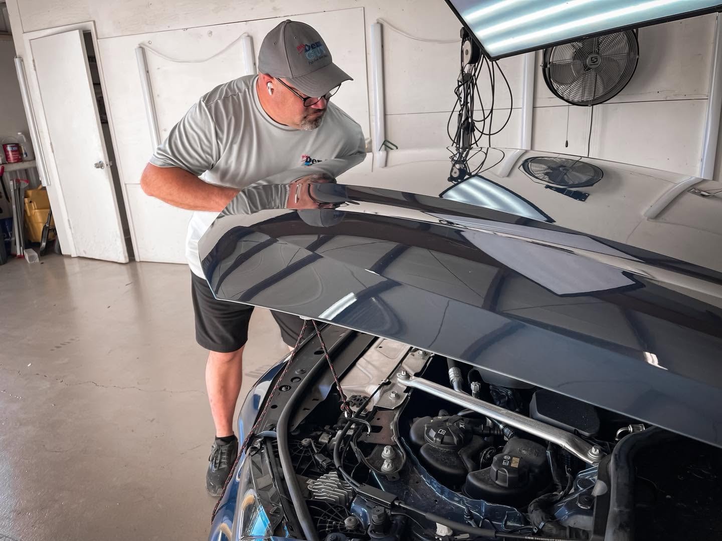 Mark Tucker performing paintless dent repair at My Dent Guy shop in Naples, Florida
